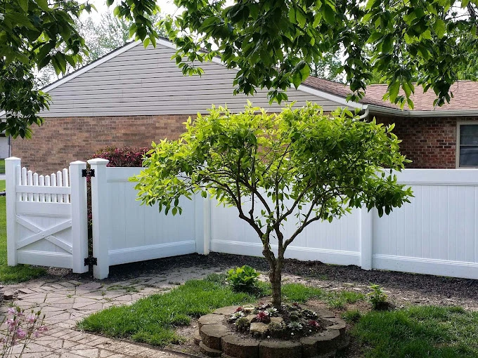 Vinyl fence installation in Beavercreek Ohio backyard with privacy panels and gate